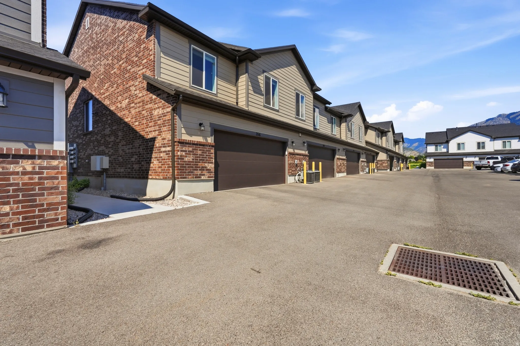 Townhome exterior featuring varied siding and brick accents