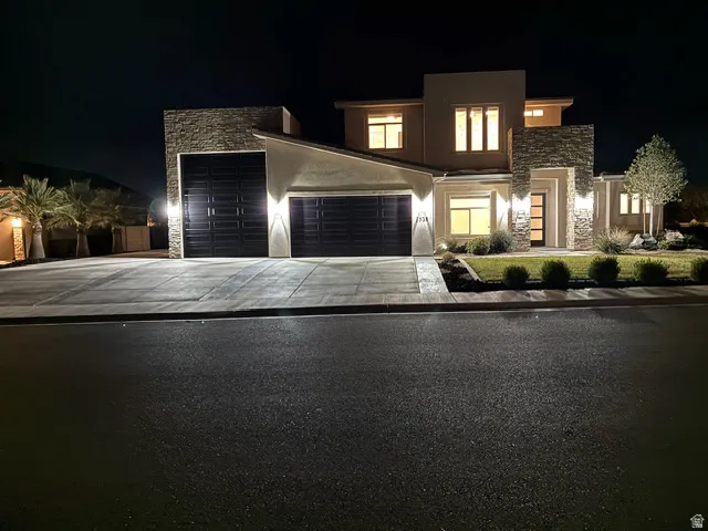 Contemporary stucco exterior featuring stone accents and multiple large windows