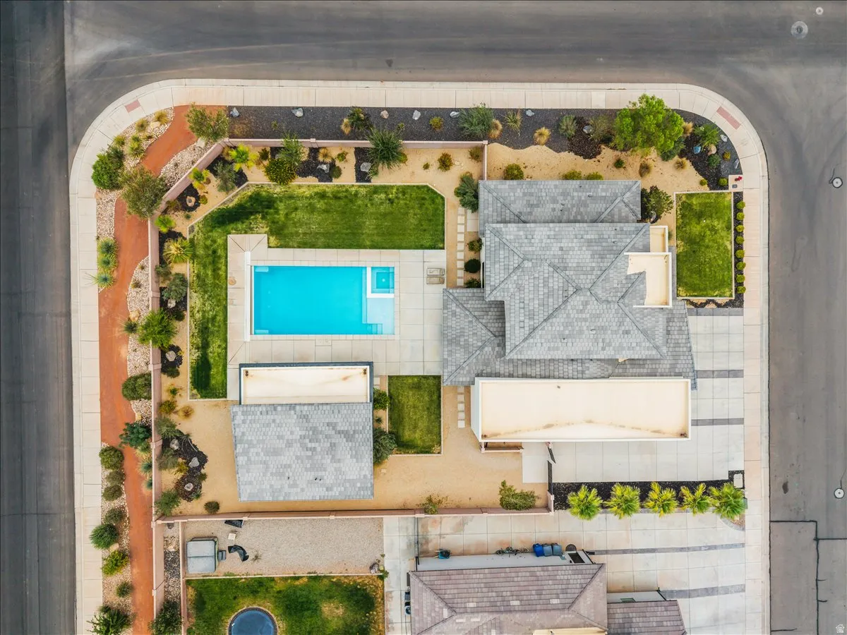 Aerial perspective showcasing a corner lot property with a swimming pool and spa