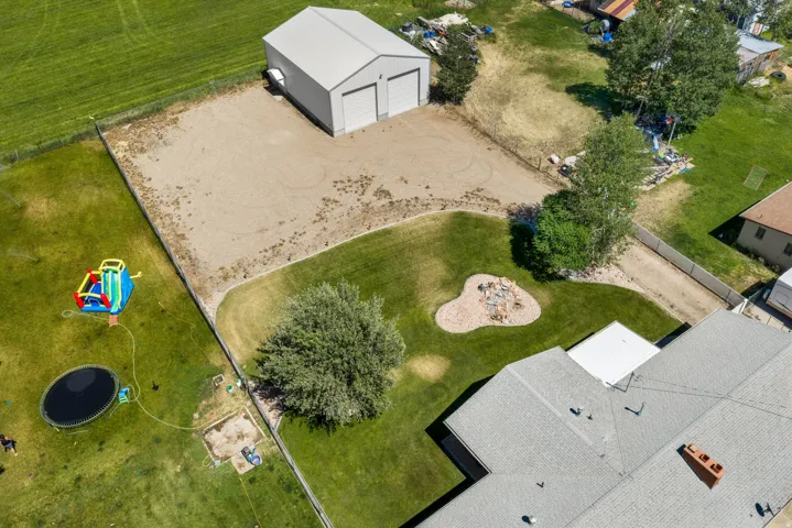Detached two-door garage with a gravel parking area
