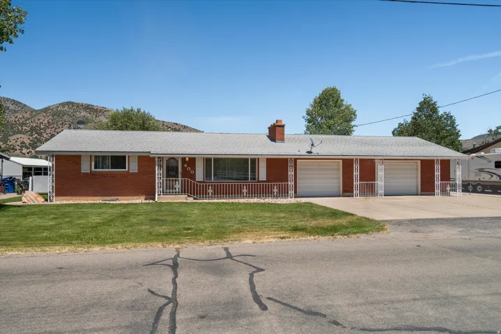 Red brick ranch-style exterior with a wide front lawn