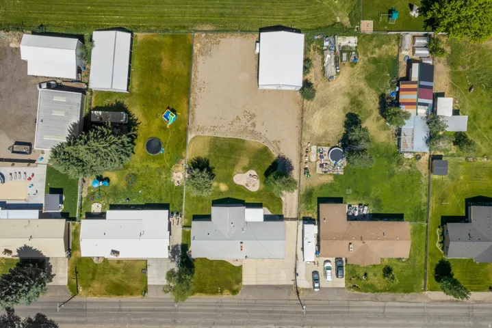 Aerial view showcasing multiple properties with extensive green spaces and various outbuildings