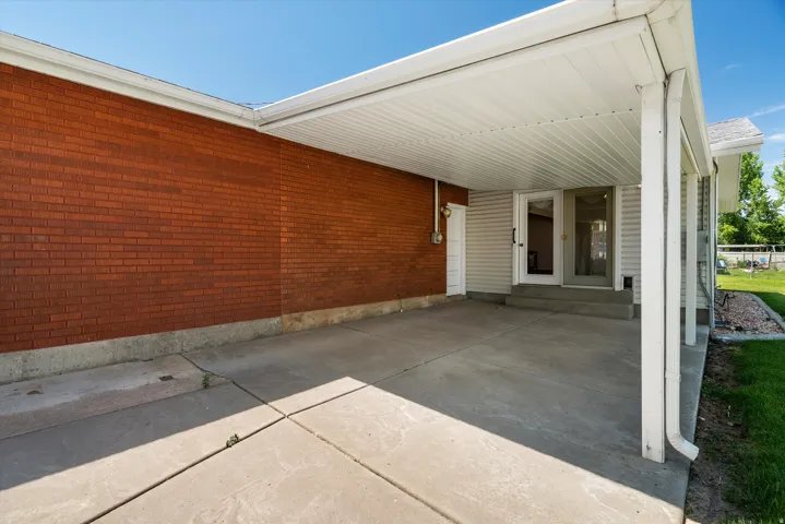 Covered concrete patio with white vinyl soffit