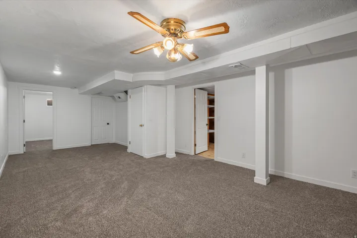 Spacious room featuring new carpeting, recessed lighting, and a ceiling fan with integrated lighting