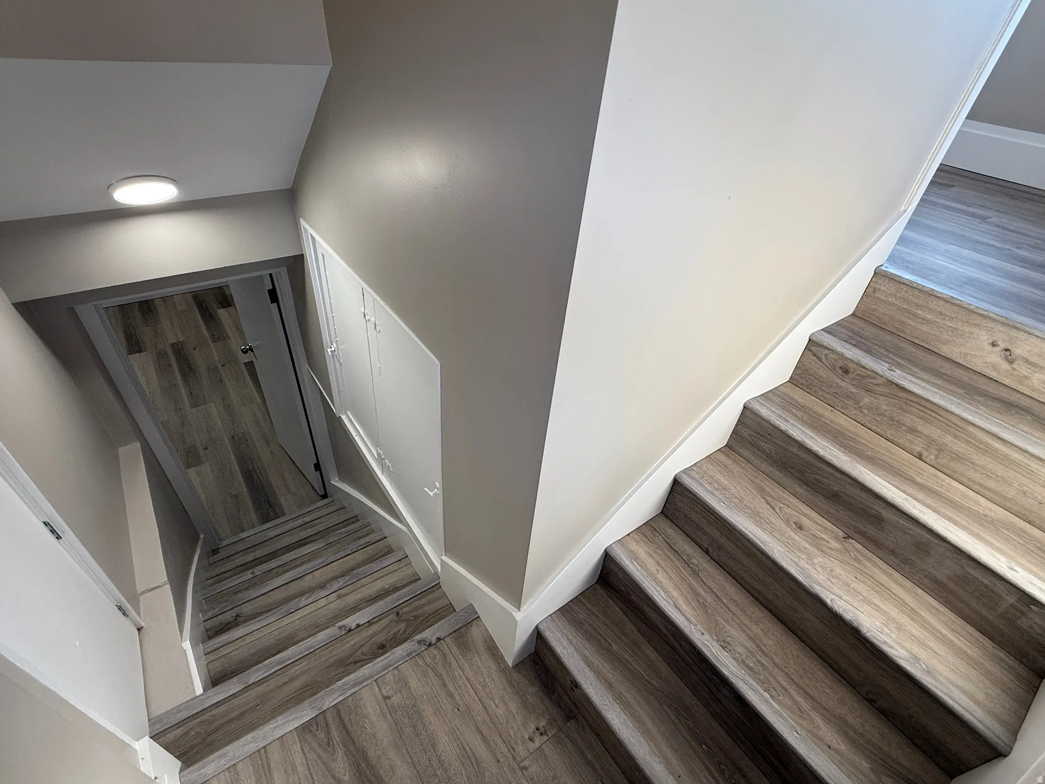 Wood-finish flooring throughout the staircase and hallway