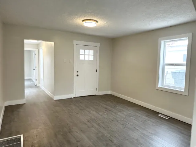 Open interior space featuring wood-finish flooring, light-toned walls, and white trim
