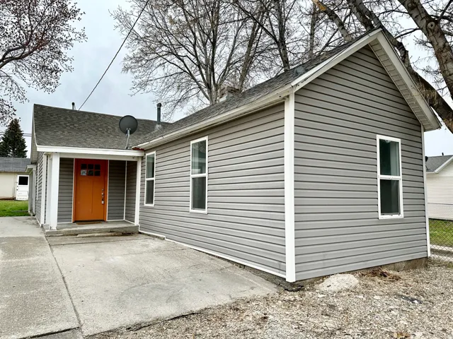 Exterior features gray horizontal siding and white trim