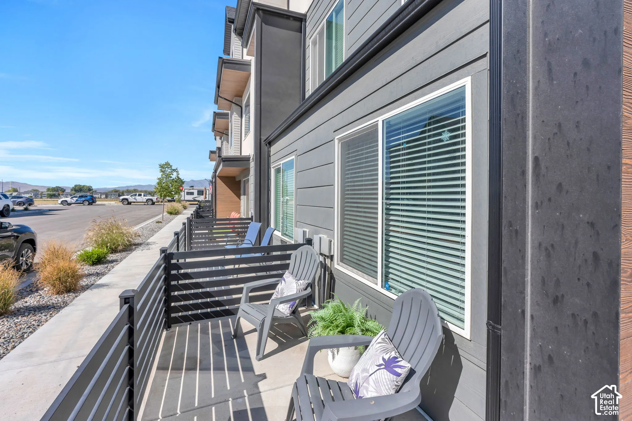 Private outdoor patio featuring slatted fencing, concrete flooring, and direct exterior access