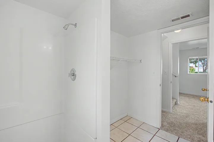 Shower enclosure with chrome fixtures