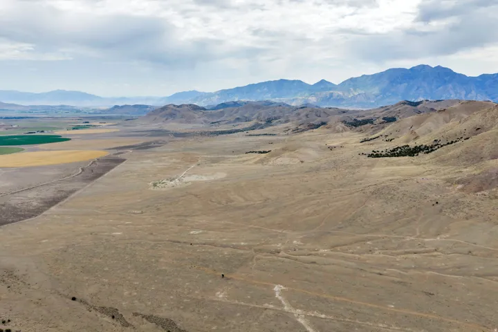 Expansive undeveloped land with distant mountain ranges