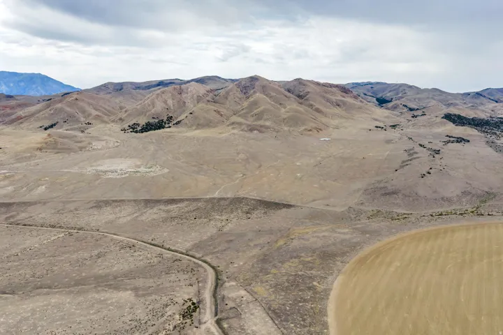 Expansive undeveloped land featuring rolling hills and distant mountains