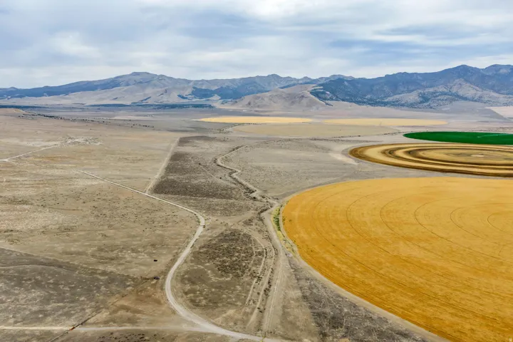 Expansive undeveloped land featuring varied terrain and distant mountain ranges