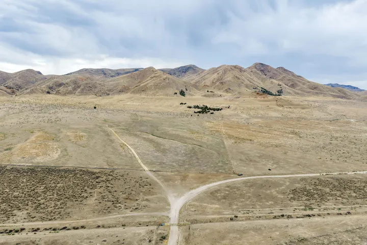 Expansive natural landscape featuring rolling hills and distant mountains