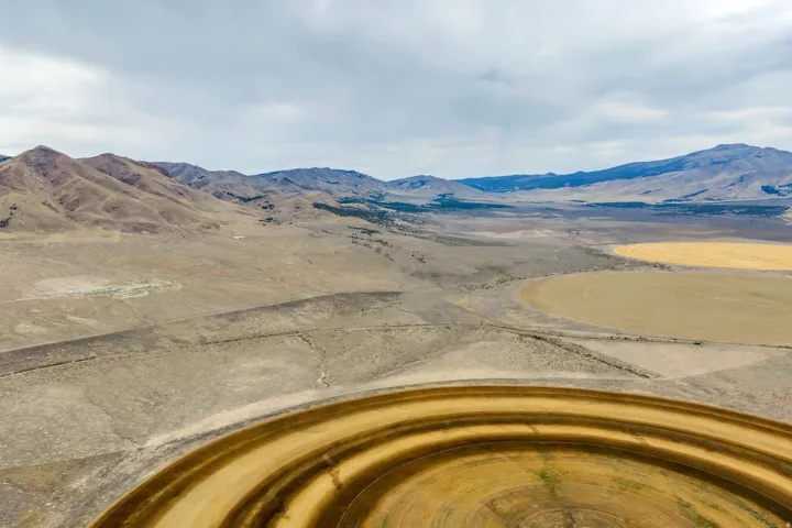 Expansive rural landscape featuring a large circular agricultural field