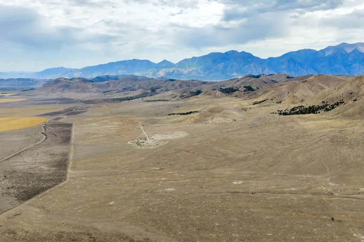 Expansive acreage featuring natural terrain and distant mountain ranges