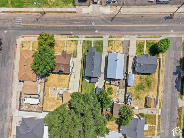 Aerial perspective showcasing multiple residential properties with varied roofing materials