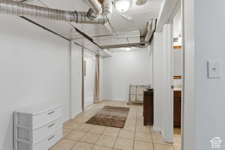 Tile flooring extends through this versatile lower-level space