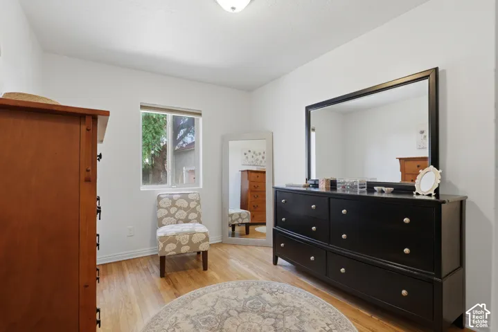 Light wood-finish flooring complements white walls in this room
