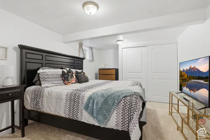 Carpeted bedroom featuring white walls and ceiling