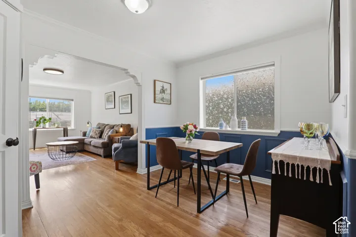 Dining area with wood-finish flooring and wainscoting