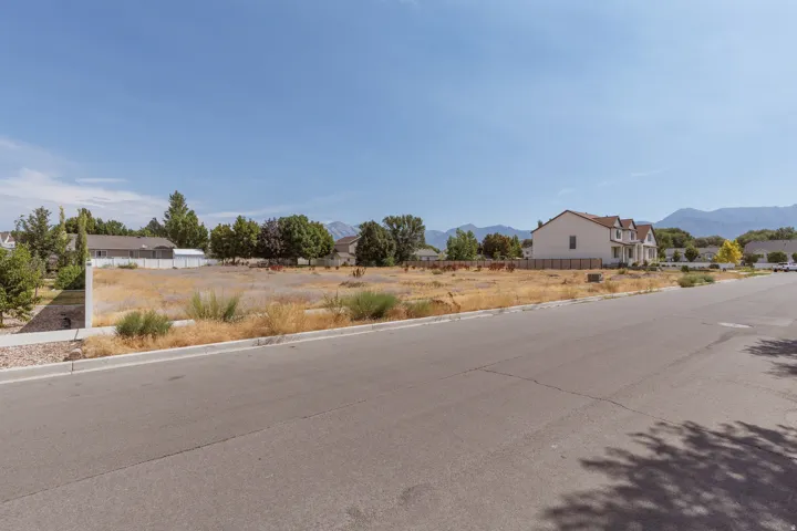 Expansive undeveloped lot featuring street frontage, a clear level building area, and a mountainous backdrop