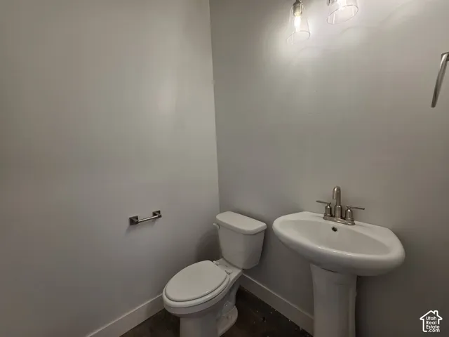 Pedestal sink with a two-handle brushed nickel faucet