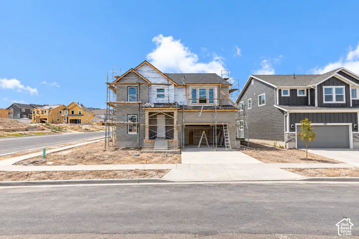 New construction residence featuring a two-car garage, covered entry, and concrete driveway