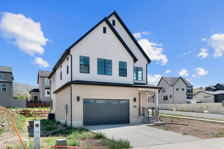 Modern farmhouse-style residence featuring a two-story design with a prominent gable roofline