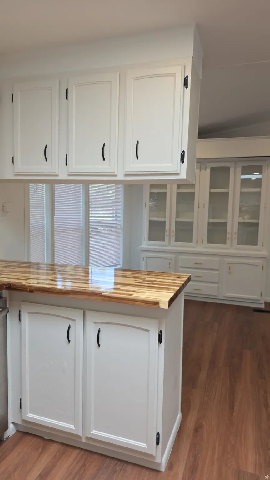 Kitchen island featuring a wood-finish countertop