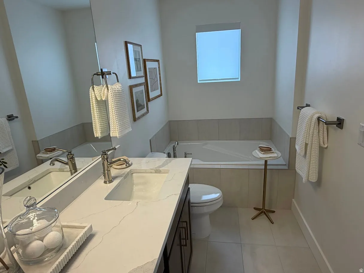 Bathroom featuring a dual vanity with a light-colored countertop, undermount sinks, and brushed nickel fixtures