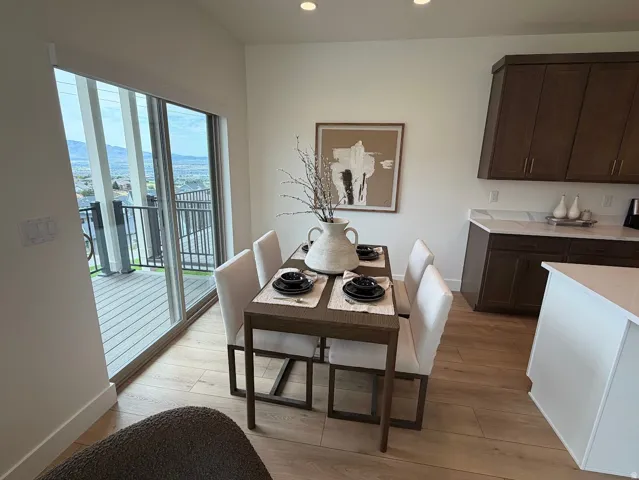 Dining area featuring wood-finish flooring and direct access to a private balcony