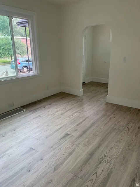 Light wood-finish flooring throughout, complemented by white baseboards and neutral wall tones