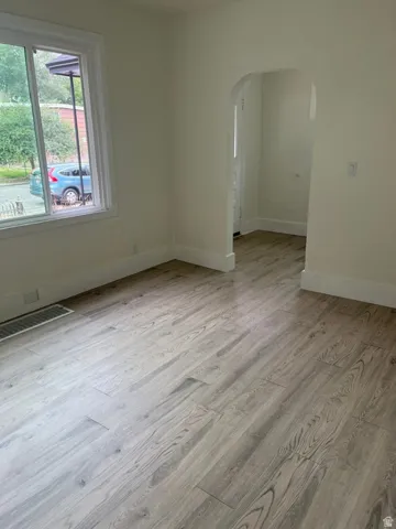 Light wood-finish flooring throughout, complemented by white baseboards and neutral wall tones