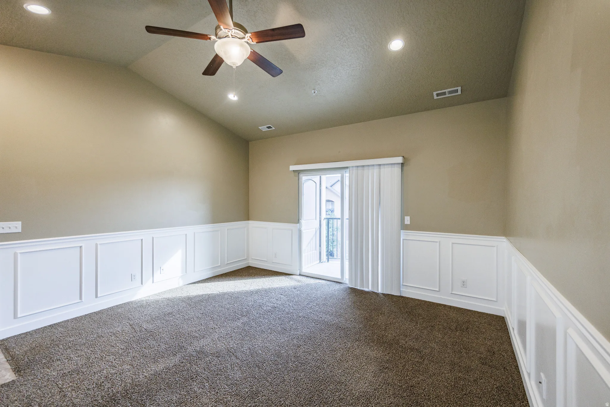 Room featuring vaulted ceilings, recessed lighting, and a ceiling fan
