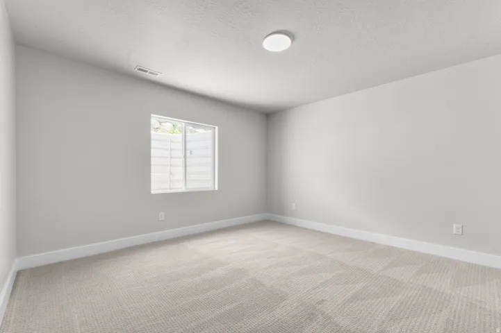 Neutral-toned carpeting and light gray walls define this room