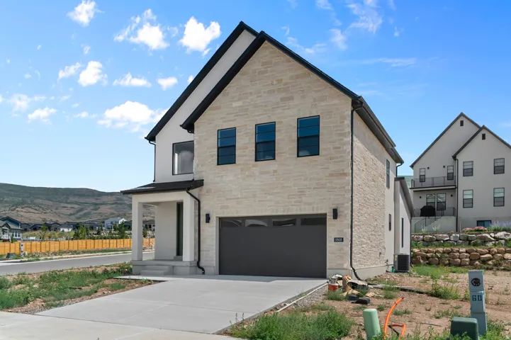 Contemporary exterior with light-toned stone and white siding accents