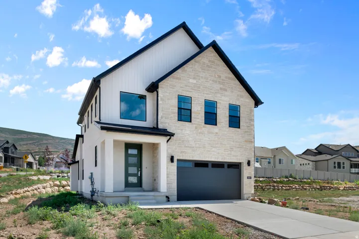 Contemporary exterior with stone facade and vertical white siding
