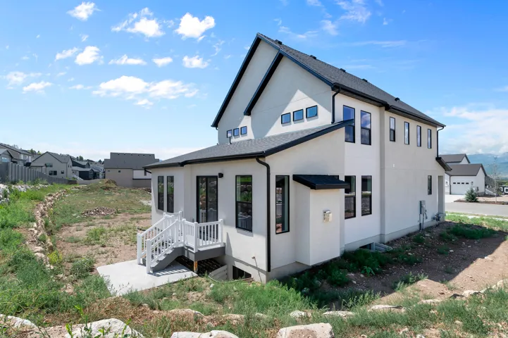 Contemporary exterior with white stucco siding and black trim accents