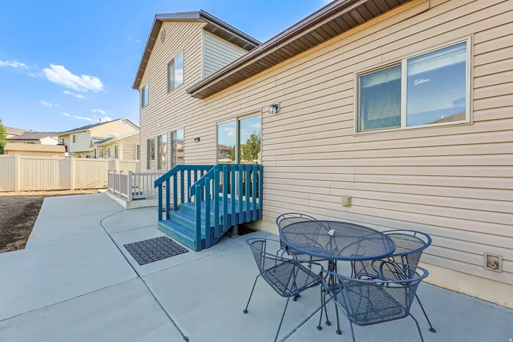 Rear exterior featuring beige horizontal siding