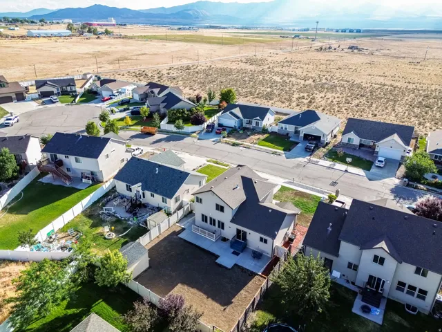 Aerial perspective showcasing a residential development bordered by open plains and distant mountains
