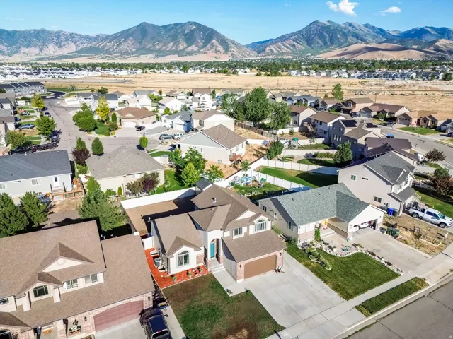 Aerial perspective showcasing a residential area with a prominent mountain range backdrop