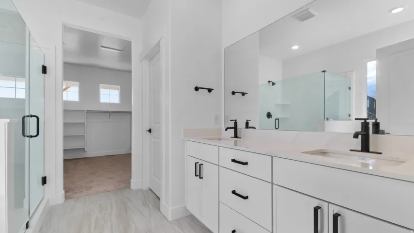 Double vanity with light-colored countertops, undermount sinks, and matte black fixtures