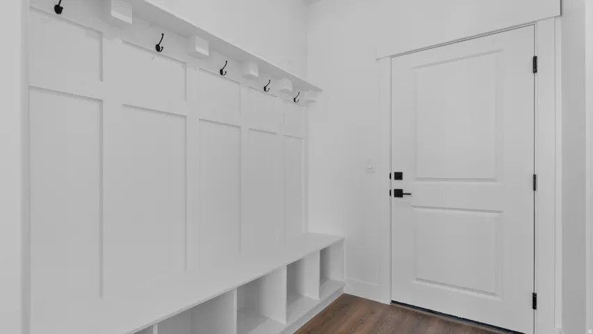 Built-in mudroom bench with cubby storage and black coat hooks