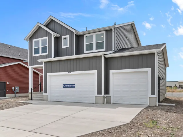 Contemporary two-story residence featuring gray vertical and horizontal siding