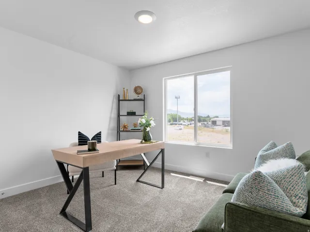 Bright room featuring a large window, recessed lighting, white walls, and neutral carpet flooring