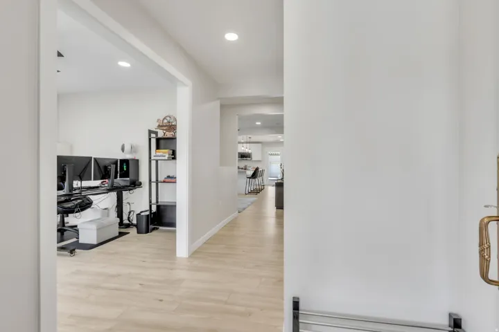 Entryway featuring light wood-finish flooring, recessed lighting, and a wide cased opening