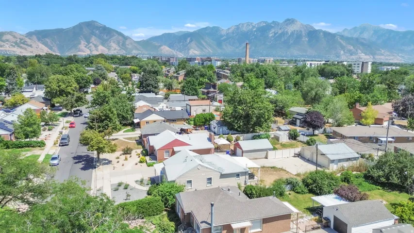 Residential neighborhood featuring mature trees and mountain scenery
