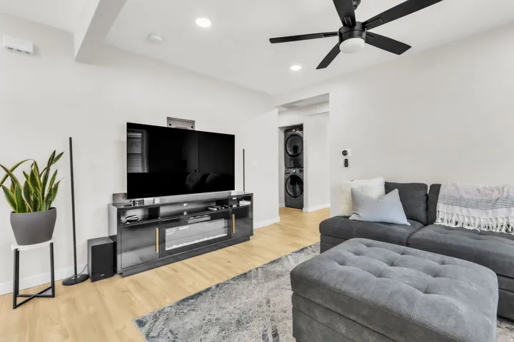 Living area featuring wood-finish flooring, recessed lighting, and a modern ceiling fan