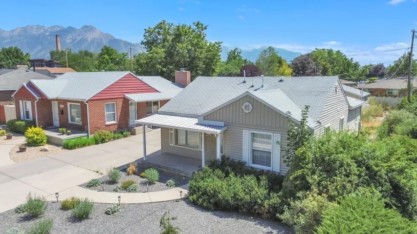 Two residences featuring a prominent mountain backdrop