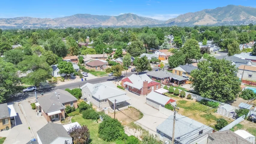 Expansive neighborhood featuring mature trees and distant mountain ranges